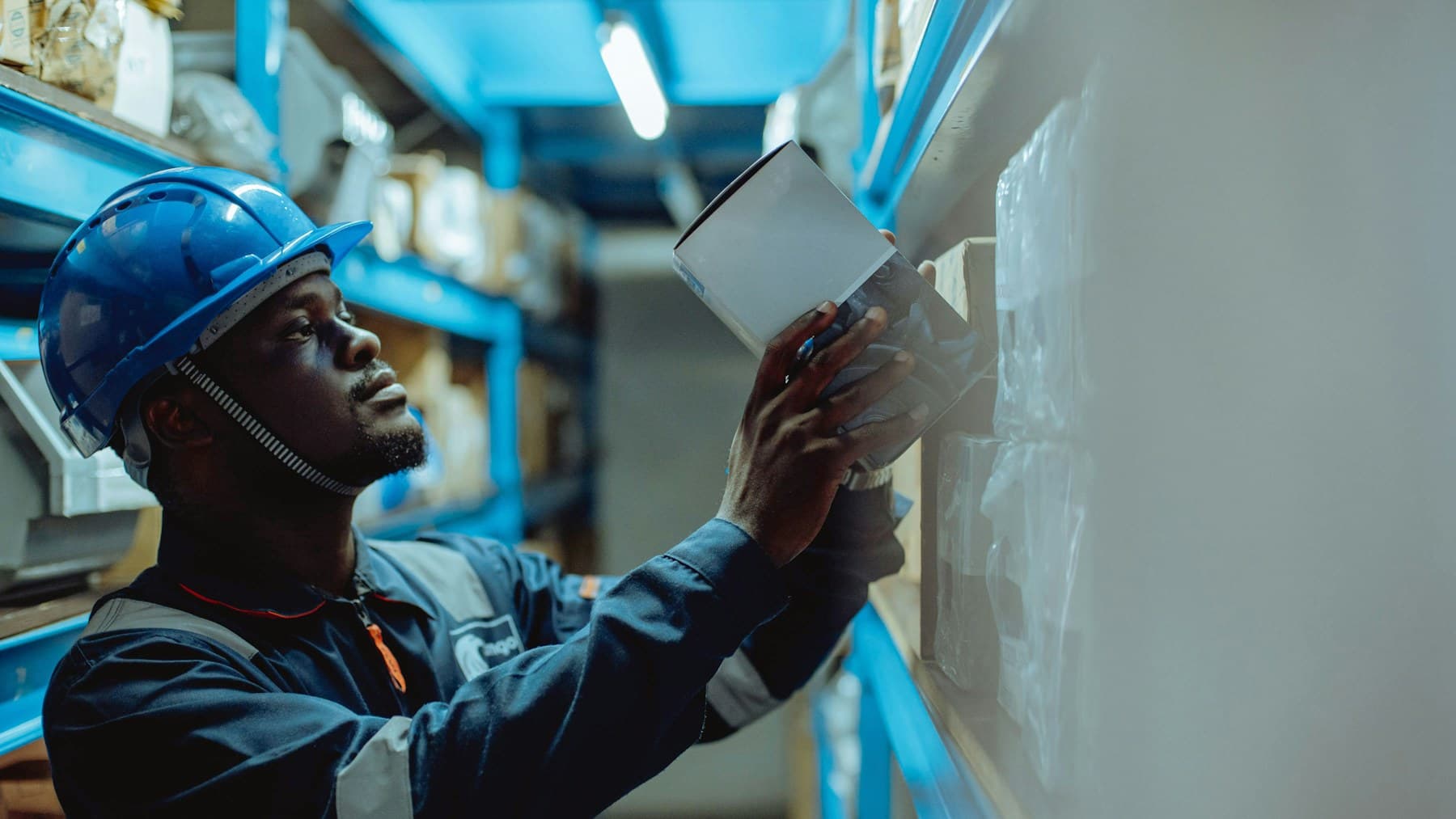 Warehouse worker scanning inventory on a shelf